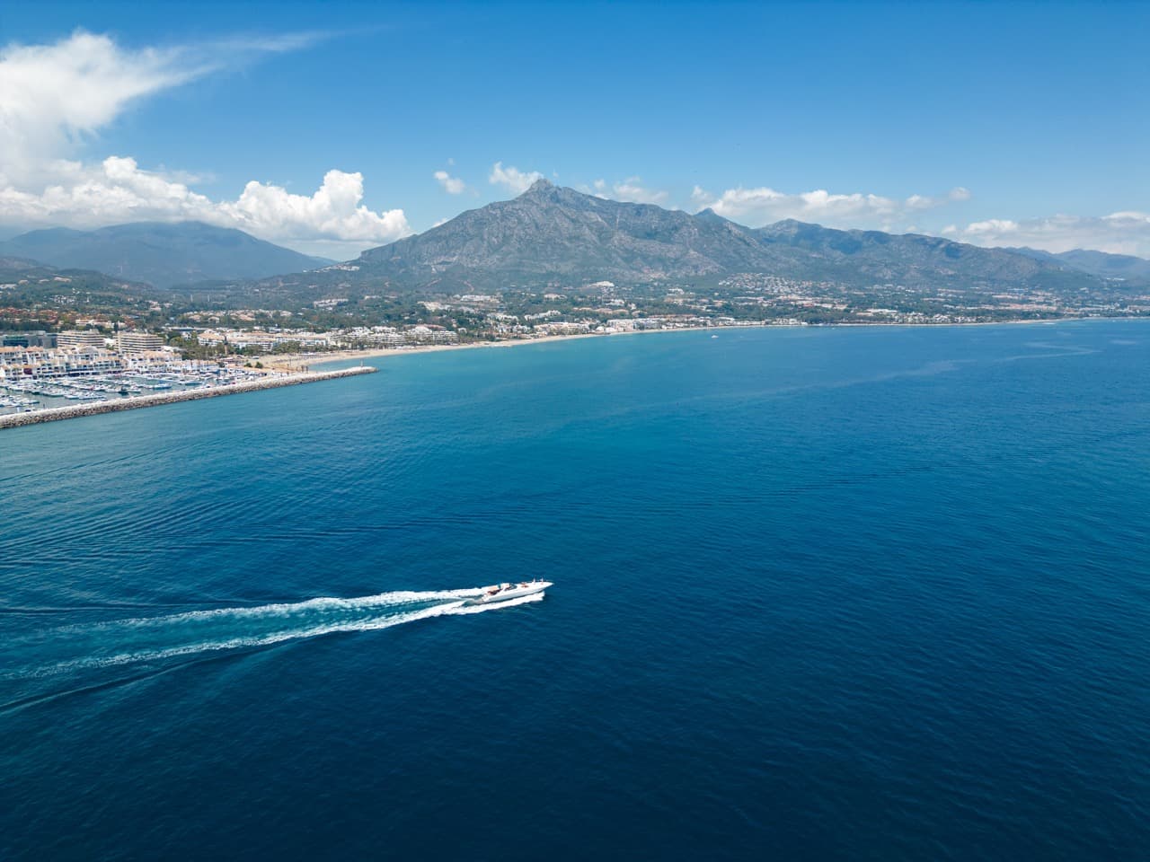 Aerial view of Puerto Banús and the Marbella coastline, La Concha mountain rising behind.